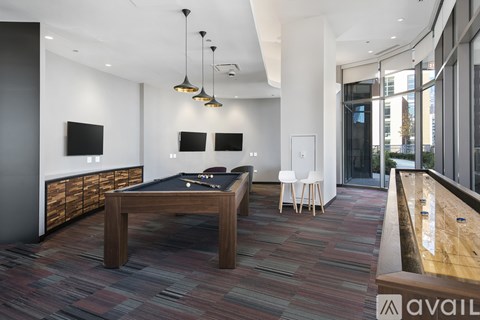 A room with a pool table and a television.