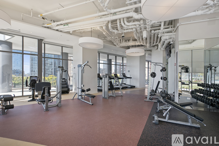 A gym with a variety of equipment including weights and machines.
