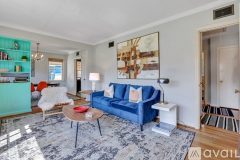 A living room with a blue couch and a coffee table.