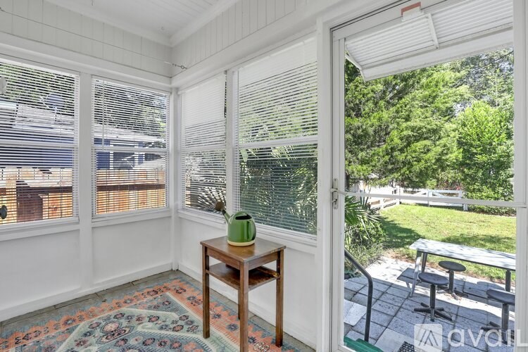 A room with a table and a vase on it.