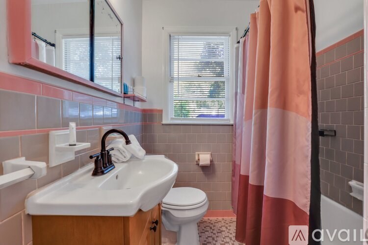 A bathroom with a sink, toilet, and shower.