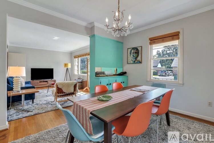 A dining room with a wooden table and chairs.