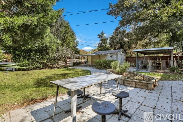 A backyard with a picnic table and a fence.