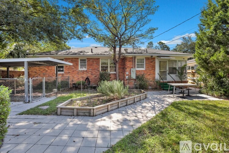 A brick house with a garden in front.