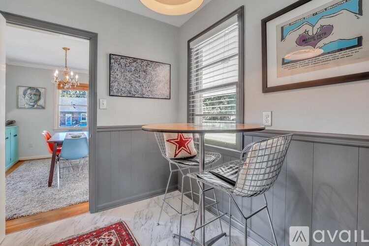 A dining area with a table and chairs.