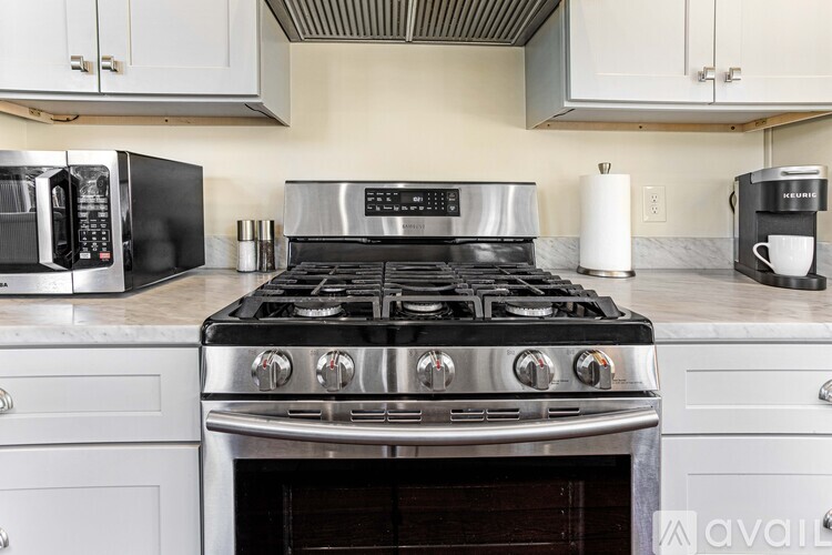 A kitchen with a stove top oven and a microwave.