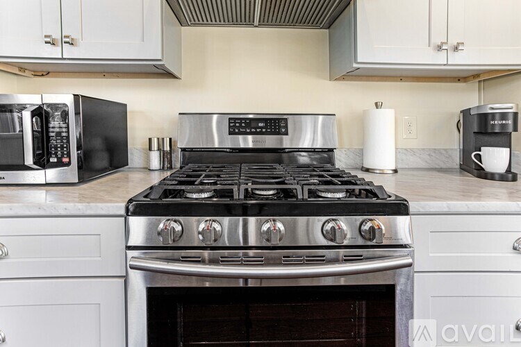A kitchen with a stove top oven and a microwave.