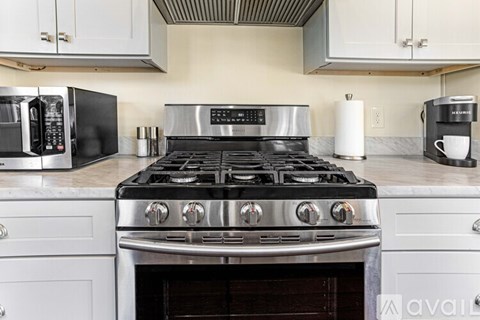 A kitchen with a stove top oven and a microwave.
