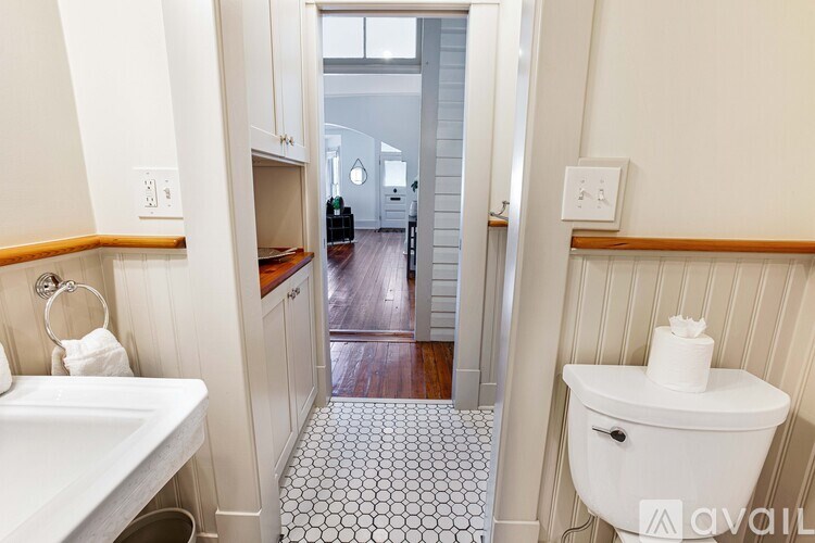 A bathroom with a white sink and toilet.