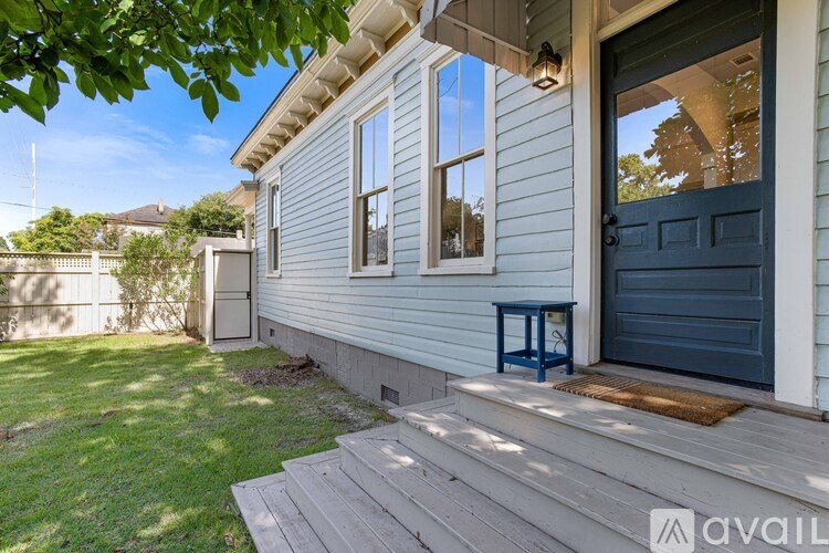 A house with a blue door and a small porch.