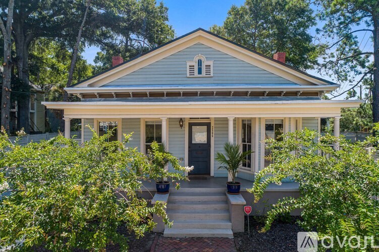 A house with a front porch and a small front yard.