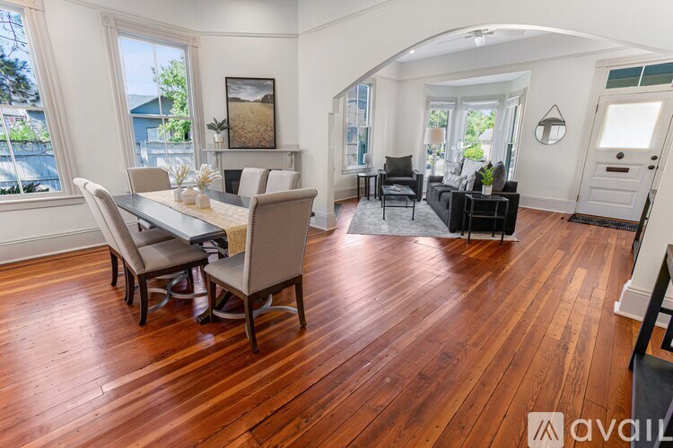 A living room with a dining table and chairs.