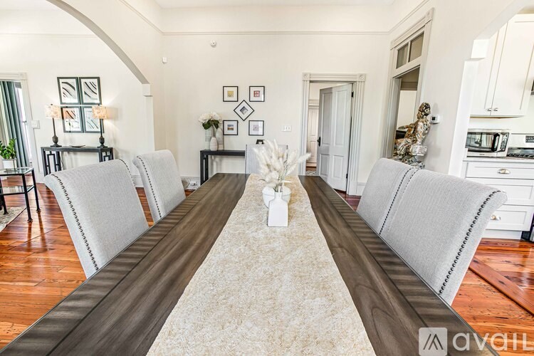 A dining room with a long table and chairs.