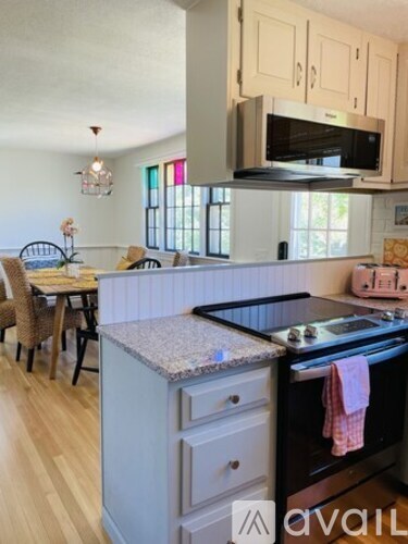 A kitchen with a granite countertop and a stove top oven.