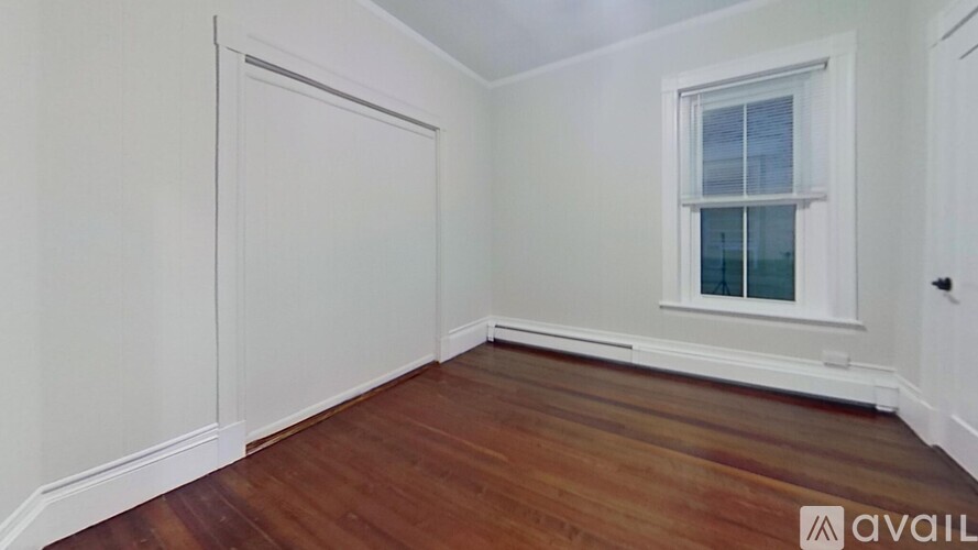 A room with wooden floors and white walls.