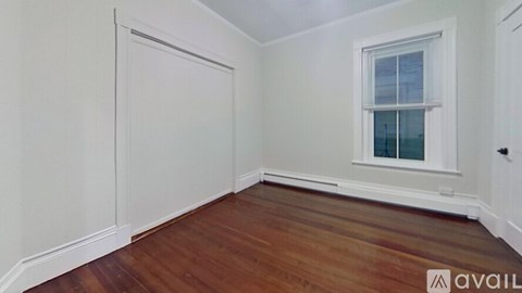 A room with wooden floors and white walls.