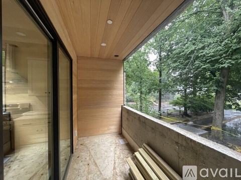 A modern house with a wooden ceiling and glass doors.