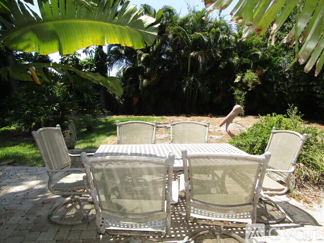 A table and chairs set outside on a patio.