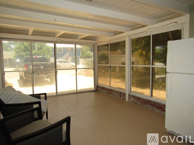 A living room with a couch and sliding glass doors.