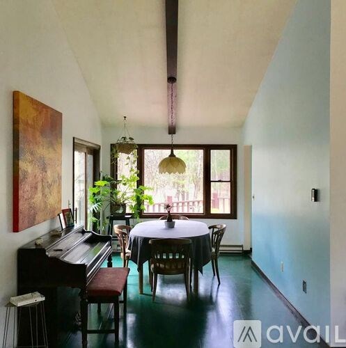 A room with a piano and a table set up for a meal.