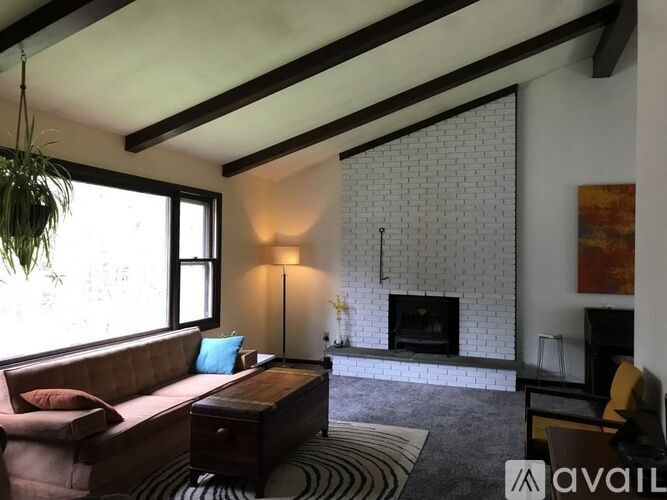 A living room with a fireplace and a couch.