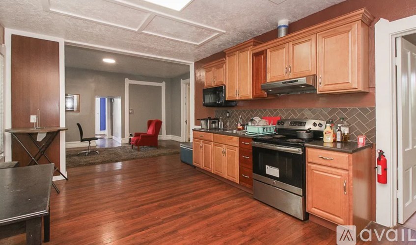 A kitchen with wooden cabinets and a stainless steel oven.
