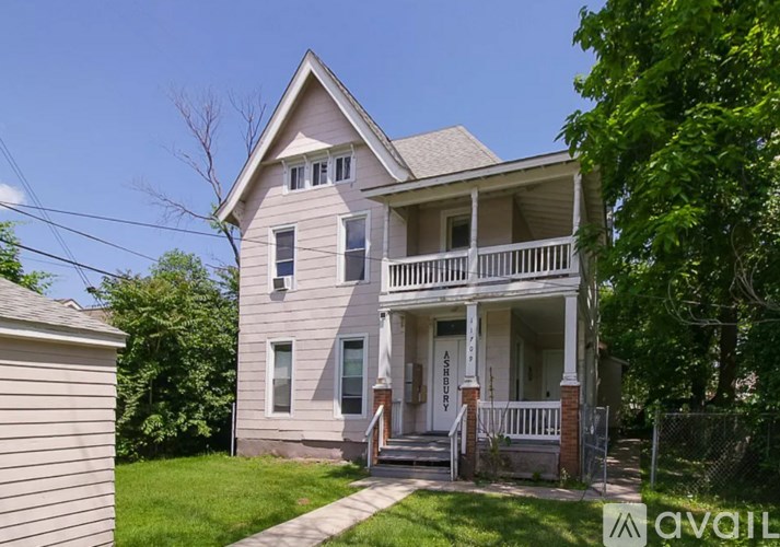 A two-story house with a front porch and a sign that says "AVAILABLE".