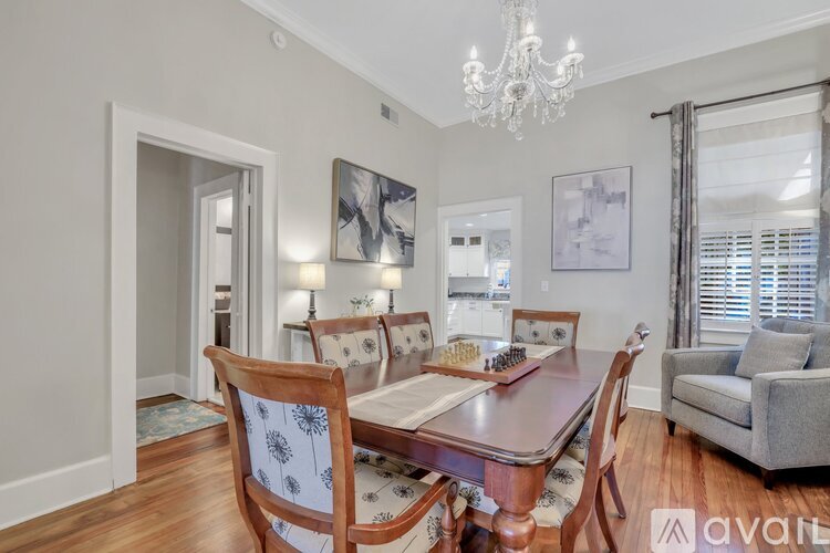 A dining room with a wooden table and chairs.