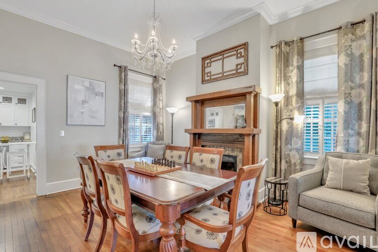 A dining room with a wooden table and chairs.