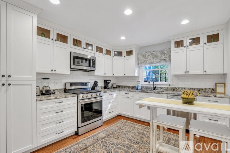 A kitchen with white cabinets and a central island.