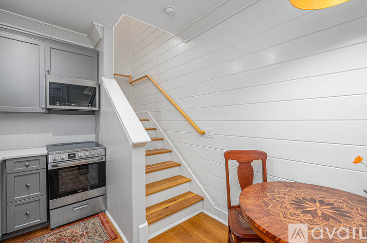 A kitchen with a stove, oven, and microwave is available for rent.