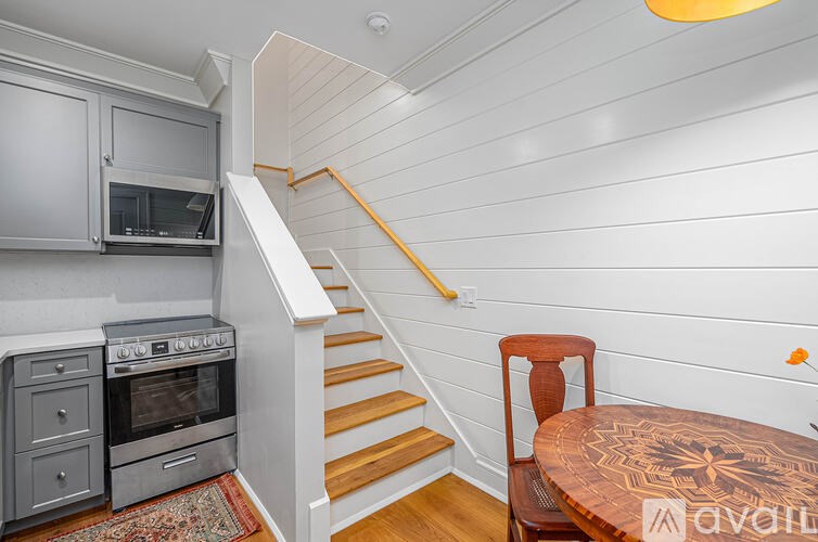 A kitchen with a stove, oven, and microwave is available for rent.