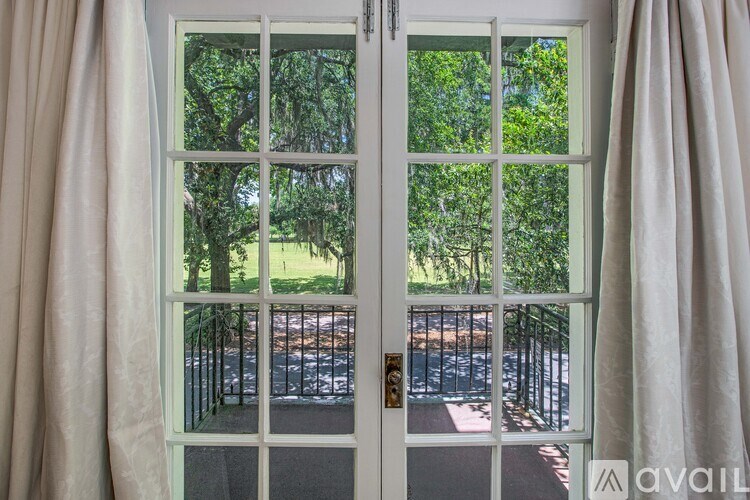 A white door with a glass window and curtains on either side.