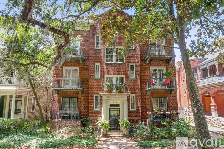 A red brick building with a black door and windows.