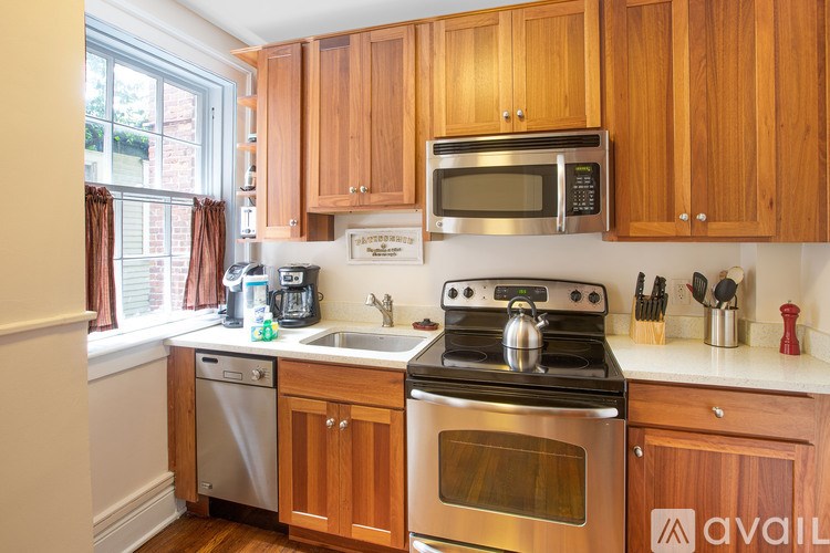 A kitchen with wooden cabinets and stainless steel appliances.