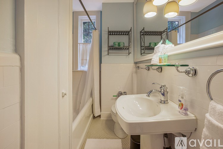 A bathroom with a white sink and a mirror above it.