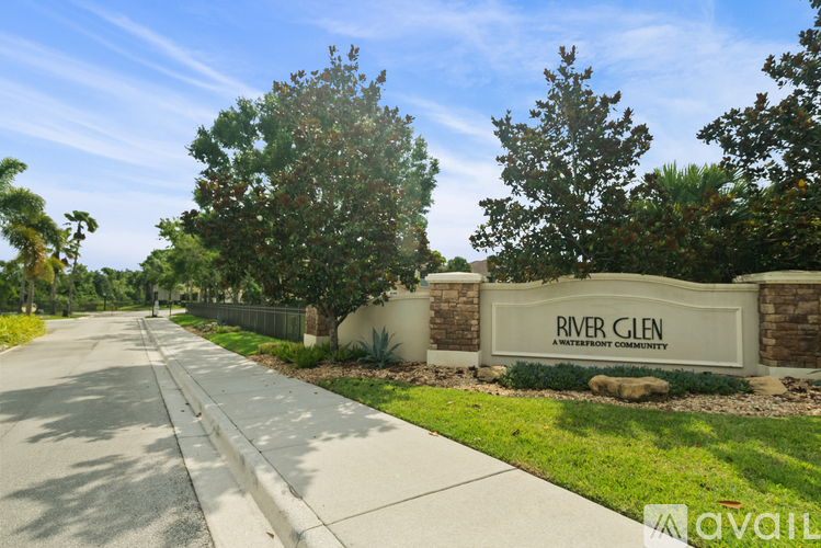 A street view of River Glen neighborhood with a signboard and trees.