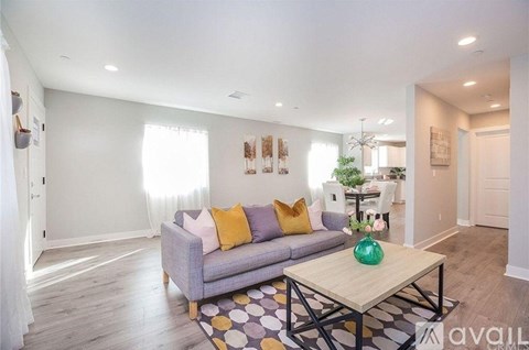 A living room with a grey couch and a coffee table.