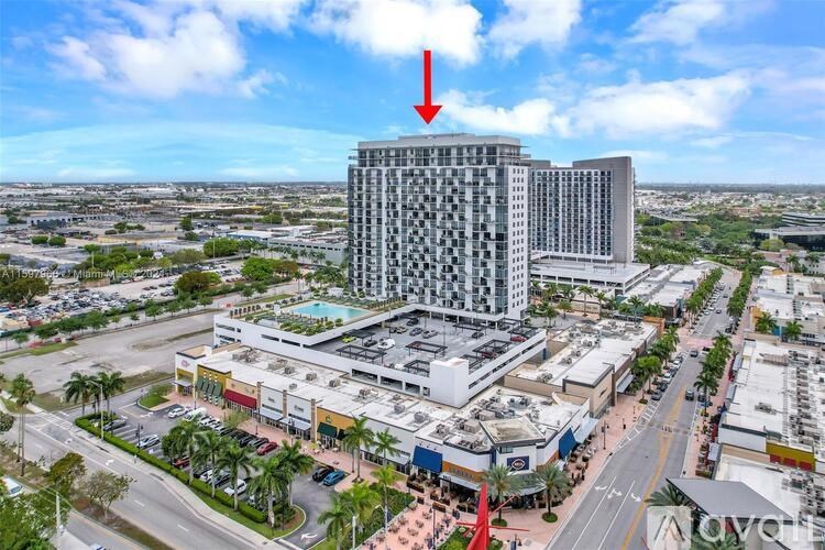 A tall building with a red arrow pointing to it.