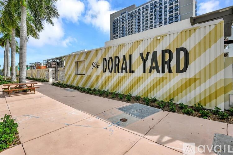 A wall with the words "DORAL YARD" on it.