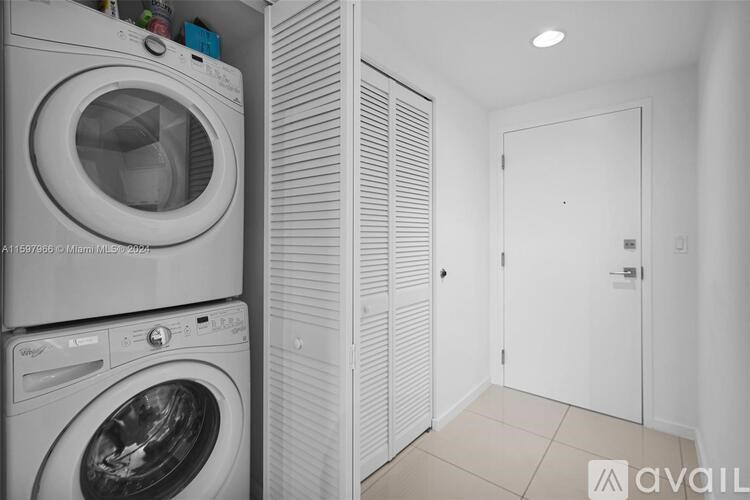 A stack of washing machines in a laundry room.
