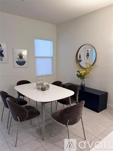 A white dining table surrounded by brown chairs in a room.