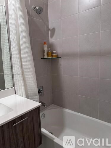 A bathroom with a white sink and a bathtub.