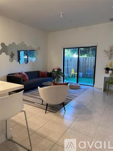 A living room with a white sofa and a glass table.