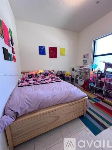 A bedroom with a bed and a window.