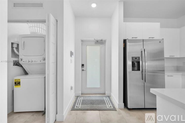 A kitchen with a white fridge and a white door.