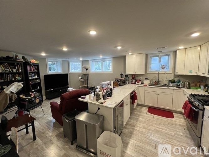 A well-lit kitchen with a dining area and a living room.