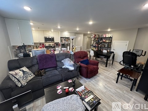 A living room with a grey couch and a coffee table in the middle.