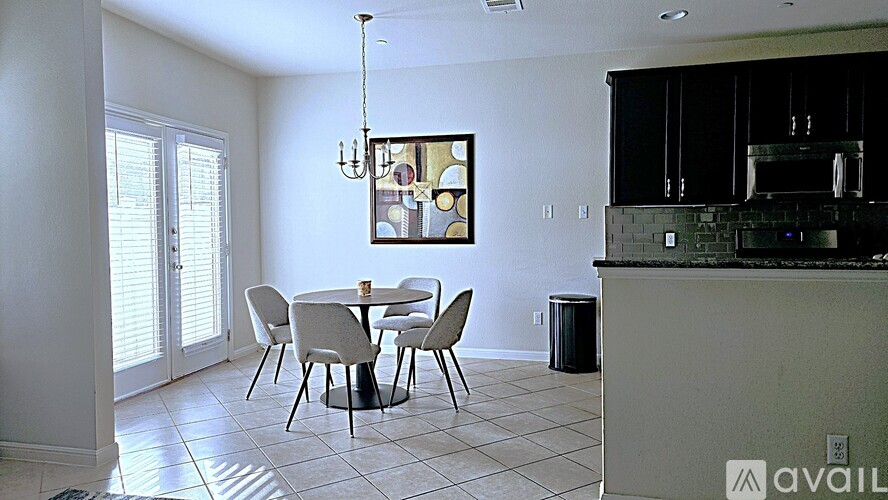 A dining room with a table set for four.