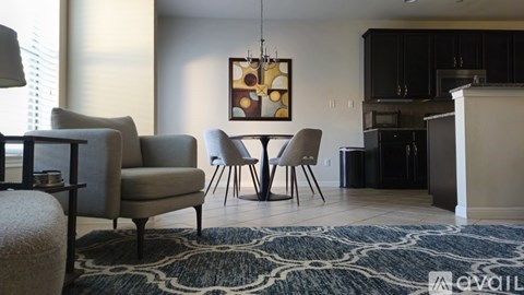 A dining room with a table set for four.